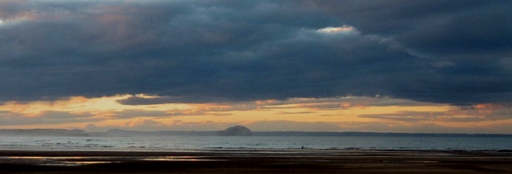 Looking NNW at sunset from Belhaven across the Biel Burn at low tide to the Bass Rock, and Fife beyond the Firth of Forth