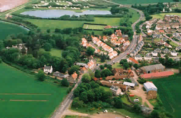 West Barns village from the Skyview photo. Seafield Pond in the centre was once part of the brickworks. The white house, Battleblent, on the right beyond the primary school, was built in the mid19th century for the brickworks owner. Digging for its foundations uncovered a trench where the bones of soldiers and horses were buried together after the battle of Dunbar more than 2 centuries earlier.